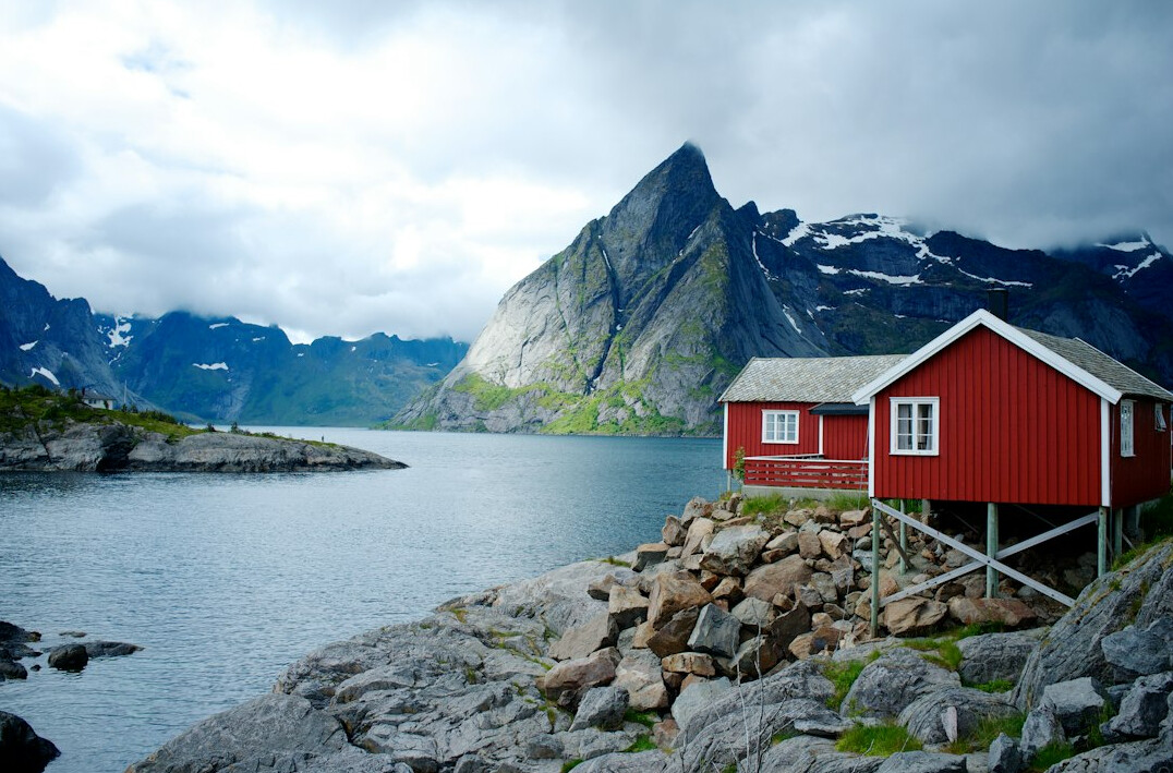 Norwegian fjord with red cabins and mountains